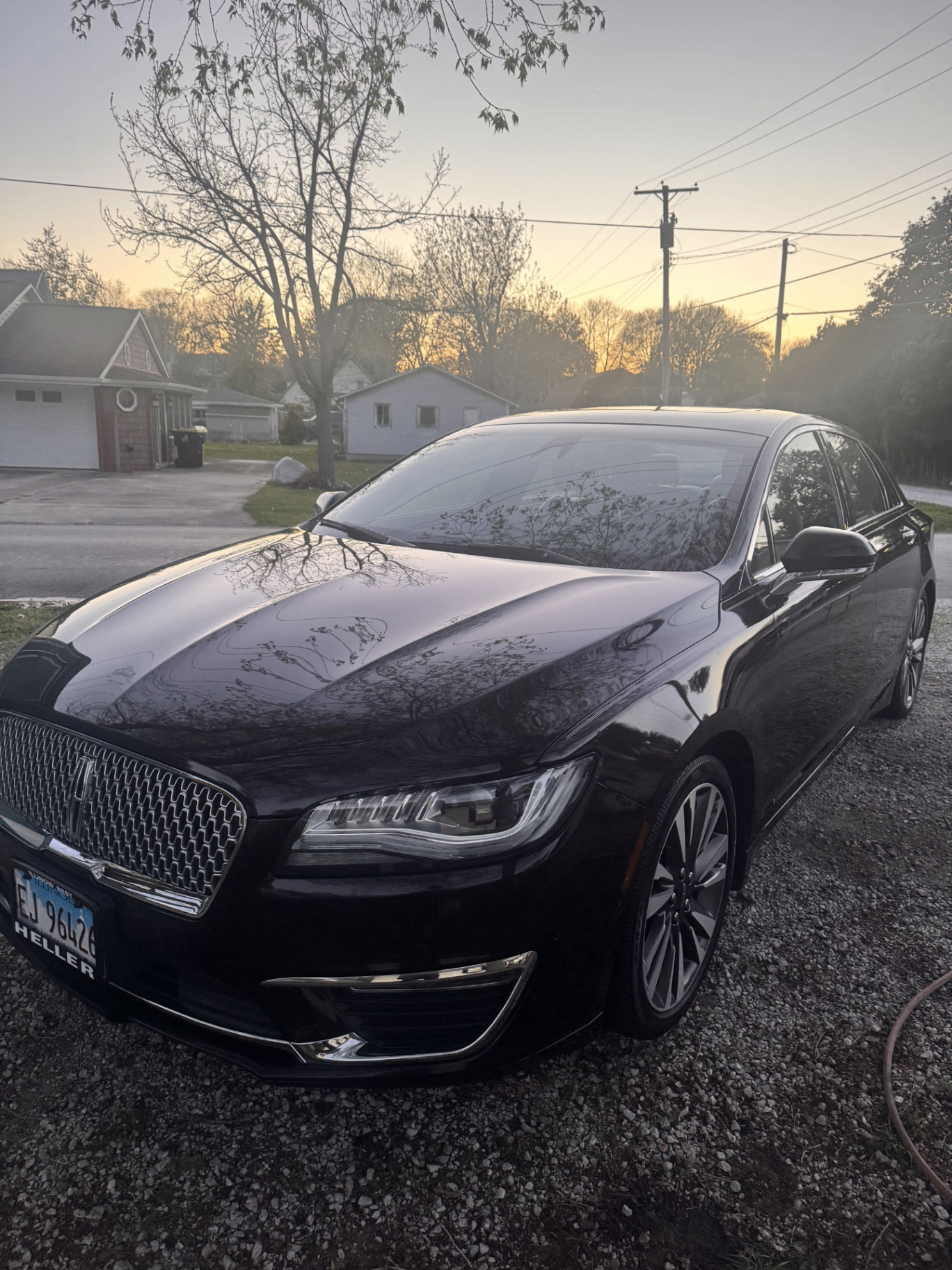 Freshly detailed black Lincoln MKZ at sunset